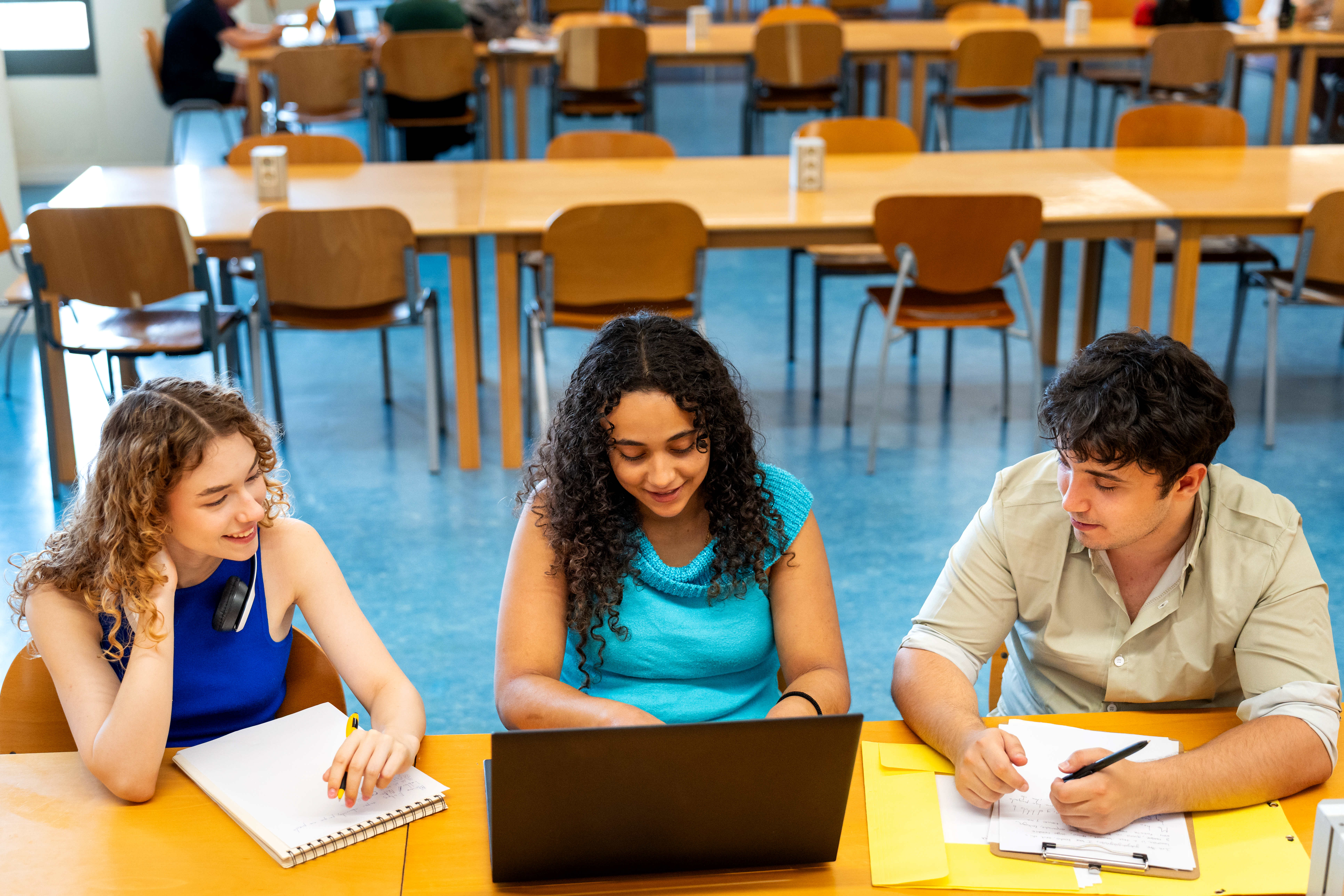 Young adults studying together at a university library, preparing for their final exams